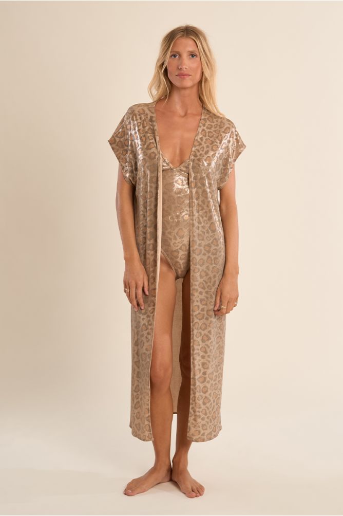 Chaqueta de mujer larga, en tejido brillante, con flecos y estampado.