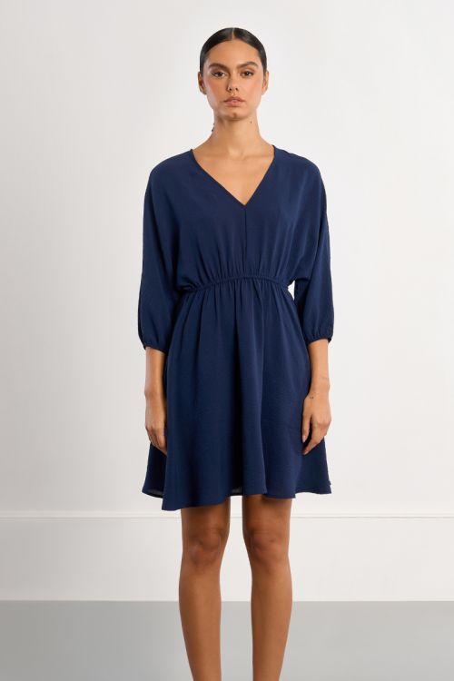 Vestido corto, de manga larga, detalle pliegues.