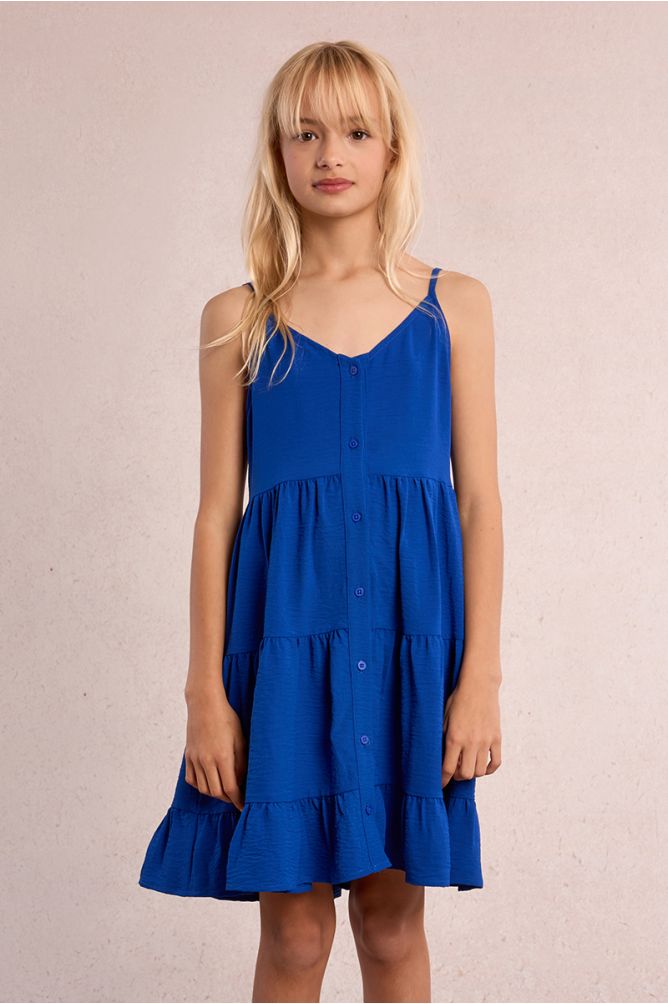 Vestido de niña de tirantes, con volantes y lazada.