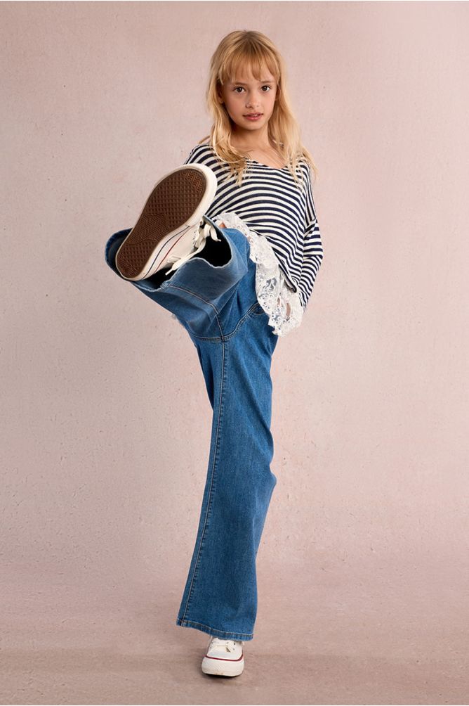 Pantalón de niña largo, vaquero, perneras anchas.