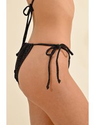 Bikini bottom in soft fabric with shiny metallic fibers, thin sliding straps on sides for adjustment.